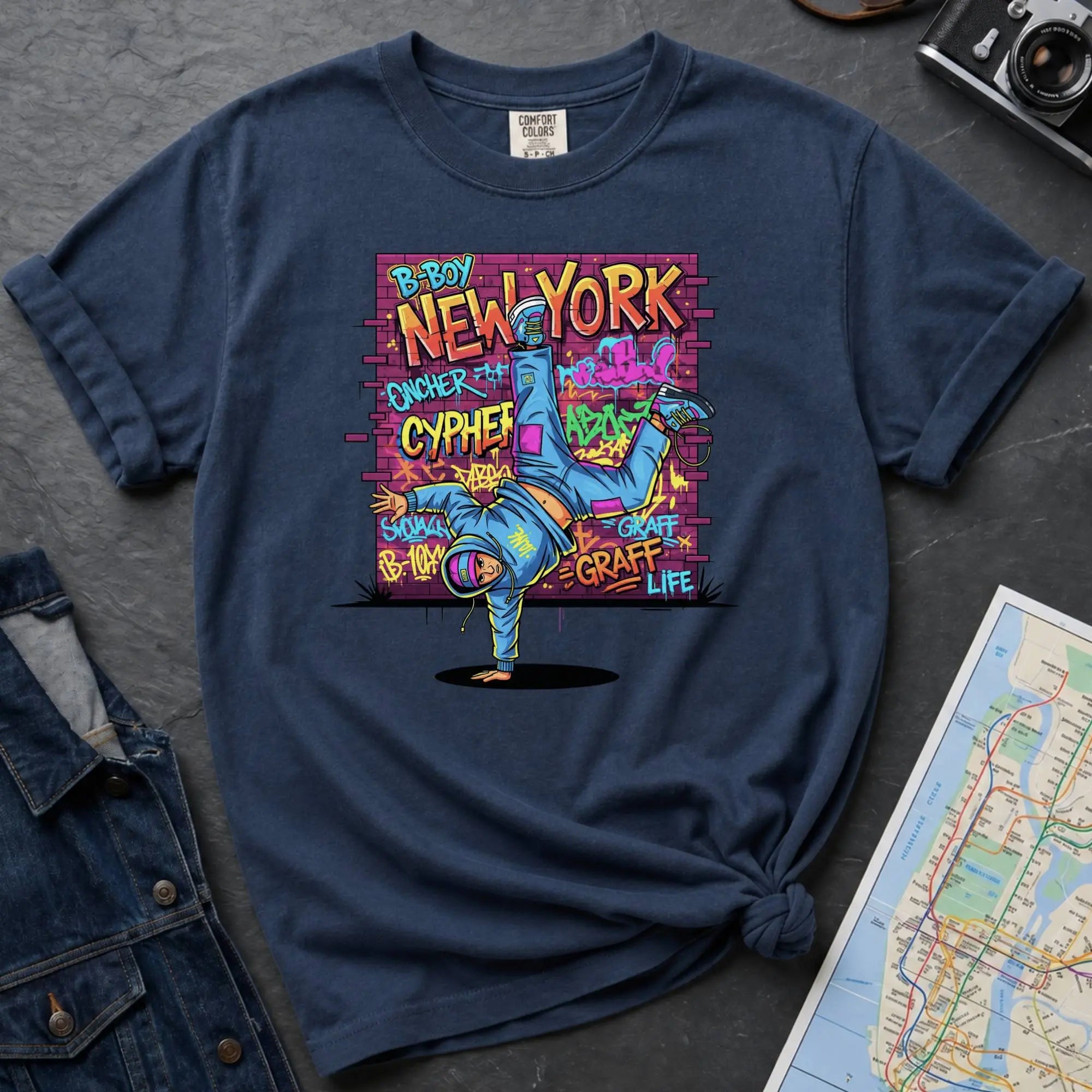 Navy Comfort Colors t-shirt featuring a colorful B-Boy New York graphic with a breakdancer in front of a graffiti brick wall.