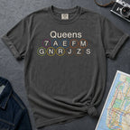Pepper colored Comfort Colors t-shirt featuring a minimalist Queens subway line graphic with Queens text and classic NYC train icons.