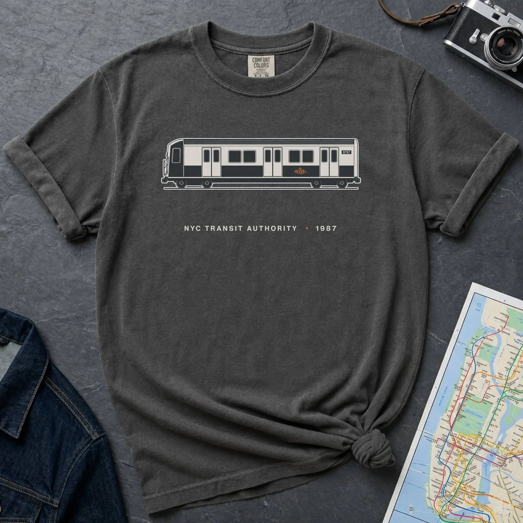 Pepper colored Comfort Colors t-shirt featuring a minimalist New York City subway car graphic with “NYC Transit Authority • 1987” text.