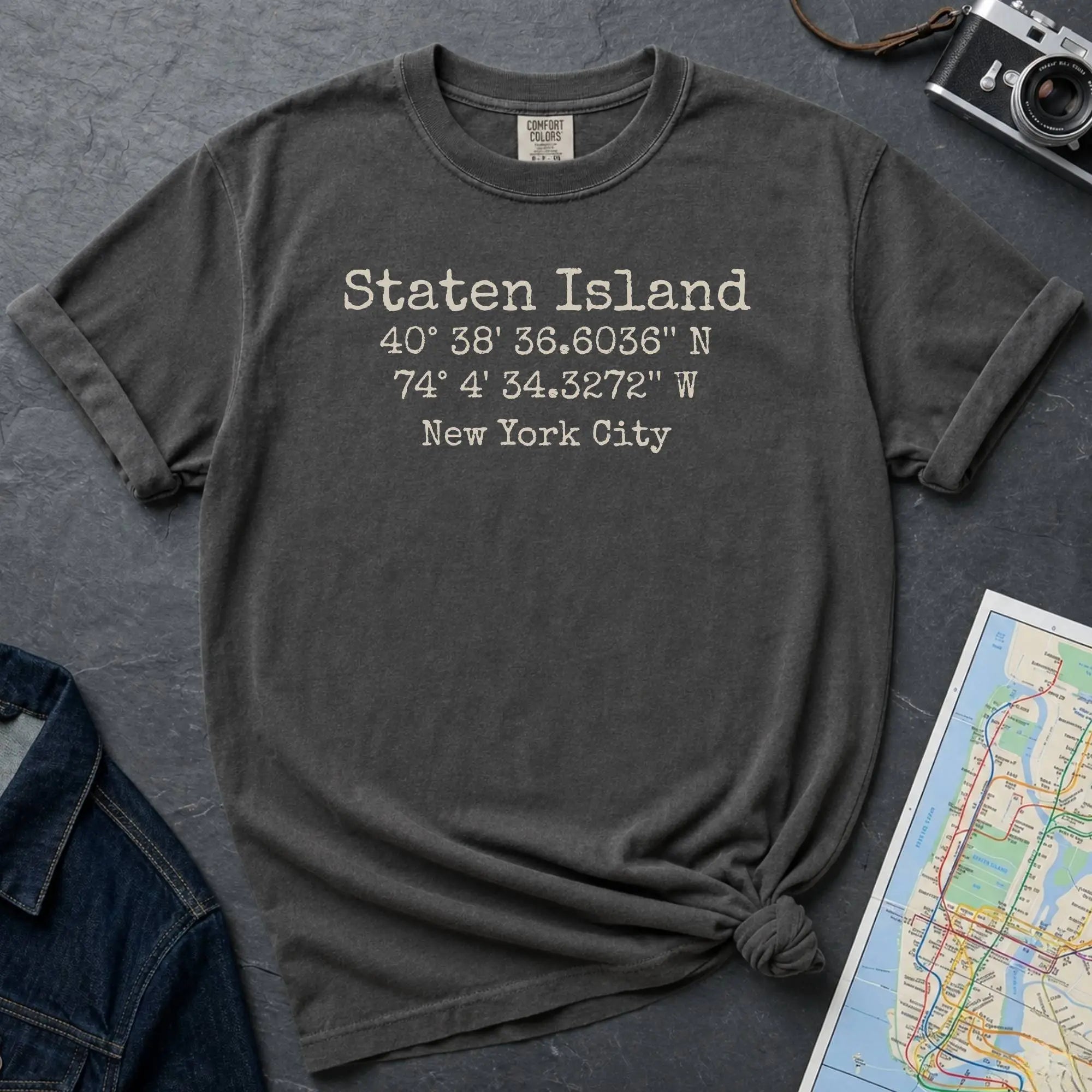 Pepper colored Comfort Colors t-shirt featuring a minimalist Staten Island coordinates design with “Staten Island,” latitude and longitude, and “New York City” printed in a vintage-style font.