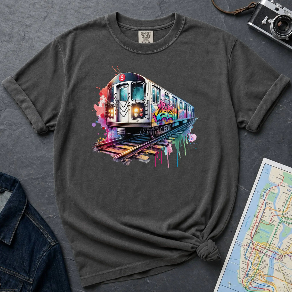 Pepper colored Comfort Colors t-shirt featuring a colorful NYC subway train graphic with graffiti-style paint details and bright street art accents.
