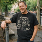 Man wearing a black Comfort Colors t-shirt with 'Summer in New York' design, standing outdoors.