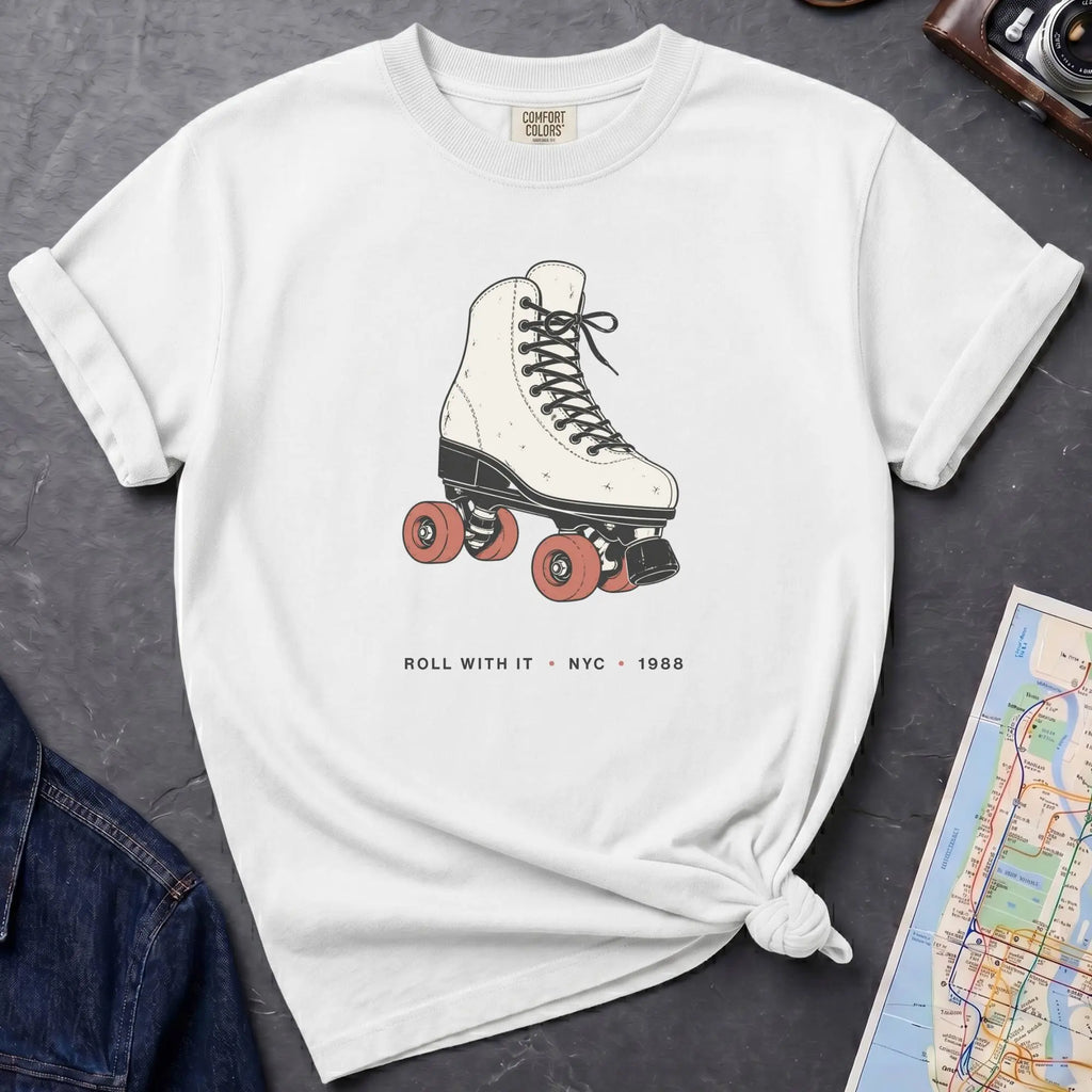 White Comfort Colors t-shirt featuring a vintage roller skate graphic with “Roll With It • NYC • 1988” text.