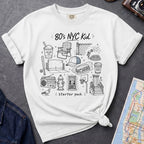White Comfort Colors t-shirt featuring an 80’s NYC Kid Starter Pack graphic with hand-drawn New York City icons including Italian ice, a radio, stoop steps, stickball, a fire hydrant, and a pigeon.