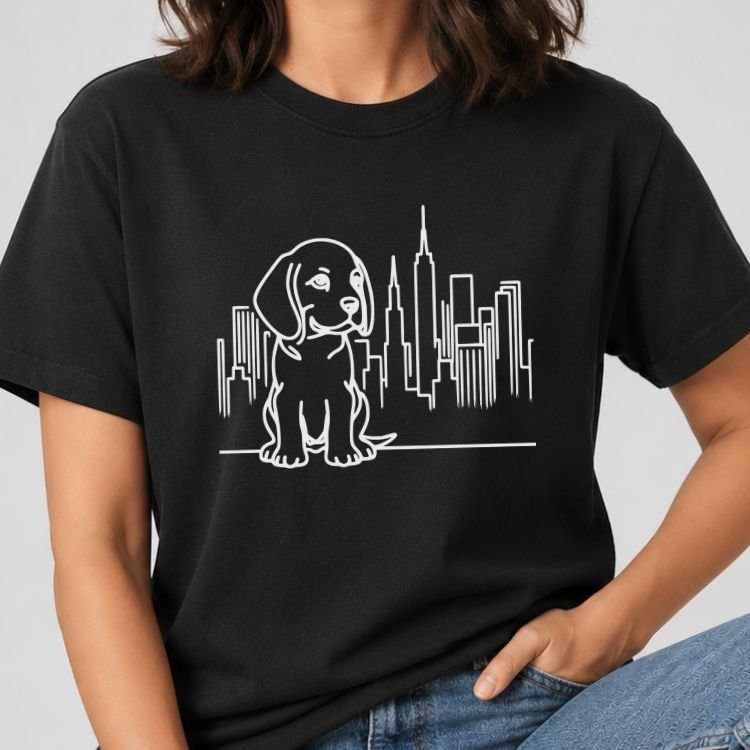 Black t-shirt with black line art of a beagle puppy sitting in front of the NYC skyline and Empire State Building