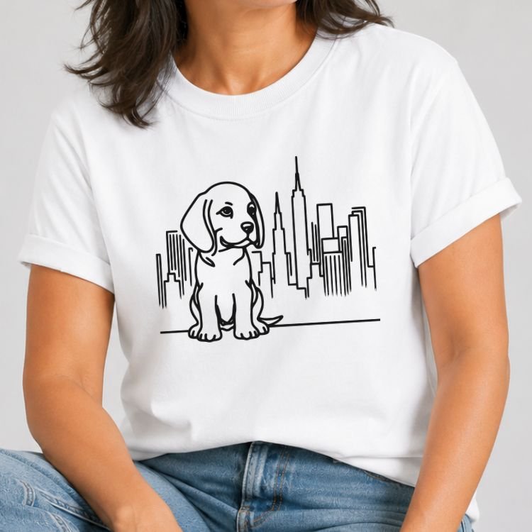 White t-shirt with black line art of a beagle puppy sitting in front of the NYC skyline and Empire State Building