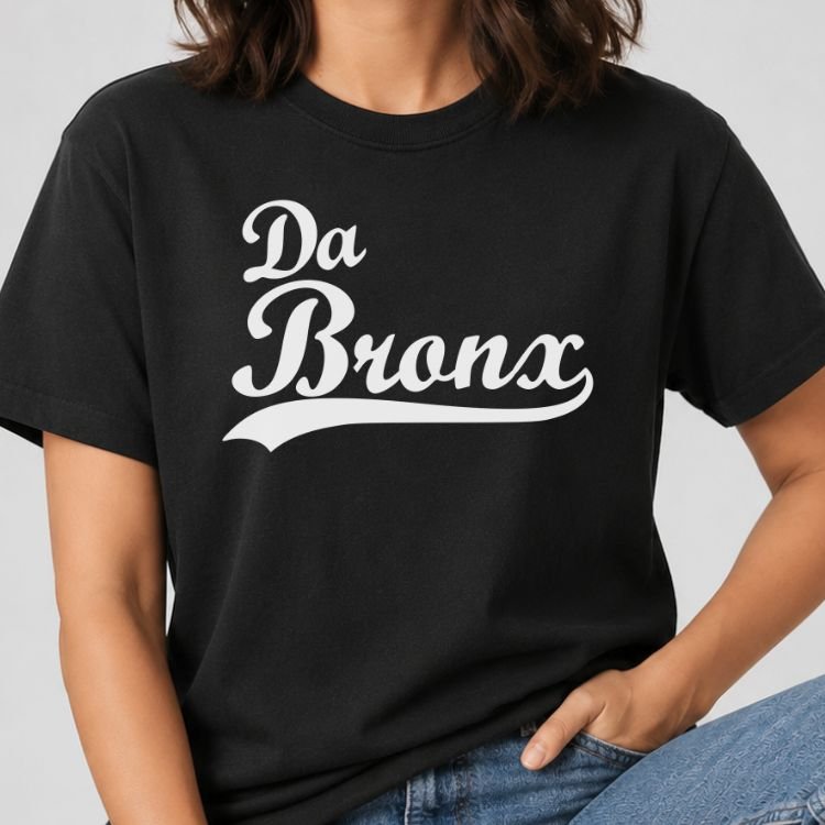 Black t-shirt with Da Bronx in white vintage baseball script lettering with a swoosh tail underline